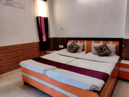 a bedroom with a large bed in a room at Shraddha Hotel in Alīgarh