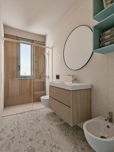 a bathroom with a sink and a toilet and a mirror at Residence Danio in Alassio