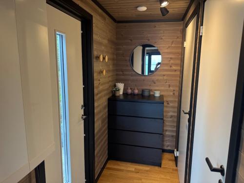 a hallway with a mirror and a dresser in a room at Hyggeli in Vadsø
