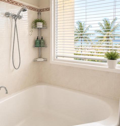 a white bath tub in a bathroom with a window at Lumina Motel Gladstone in Gladstone