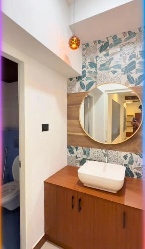 a bathroom with a sink and a mirror at Luxe Kochi Flat Backwater Views in Cochin