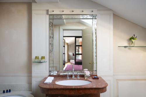 a bathroom with a sink and a large mirror at Albergo Terminus in Como