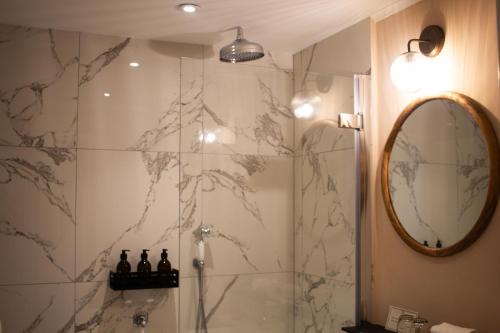 a bathroom with a shower and a mirror at The Arundell in Lifton