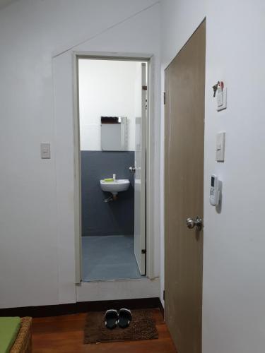 a bathroom with a sink and a door with a mirror at Feelgood dive resort in Basbas
