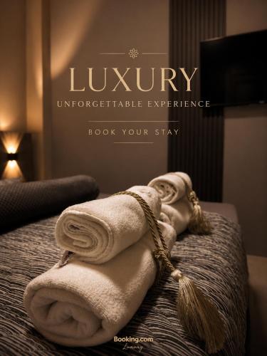 a pile of towels sitting on top of a bed at NOA Luxury Apartment in Bitola