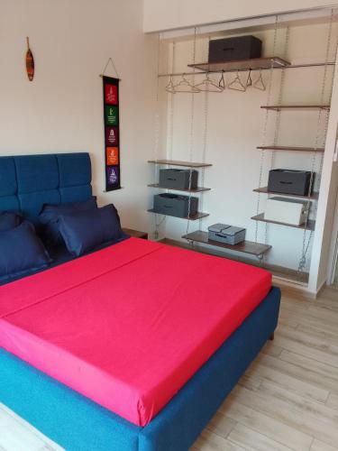 a bedroom with a large bed with a red blanket at sidi yahia,hydra in Hydra