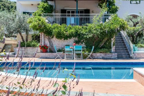 a villa with a swimming pool and a house at Nature Grand Estate - Spacious Villa with Pool in Skopelos Town