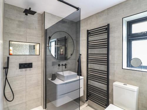 a bathroom with a shower and a sink and a mirror at 57 Howden Avenue in Doncaster