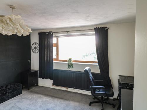a room with a desk and a chair and a window at 57 Howden Avenue in Doncaster