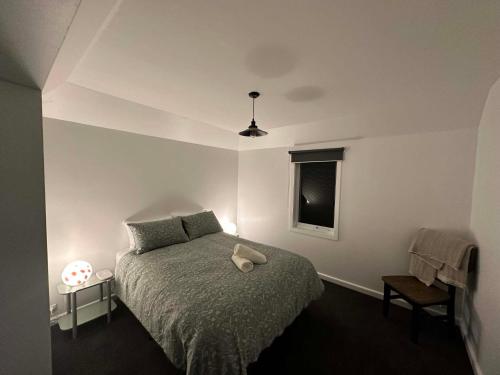 a bedroom with a bed with a teddy bear on it at Tranquillity by the sea in Killarney