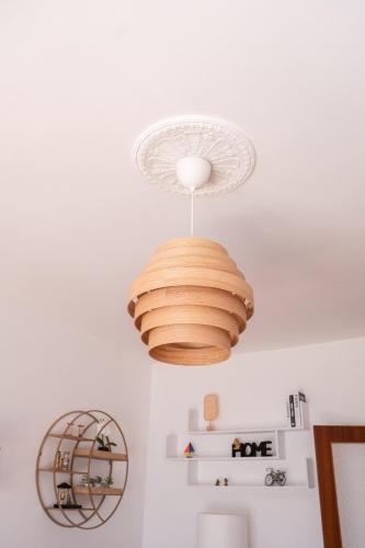 a light fixture hanging from a ceiling in a room at Kronos House in Torre del Lago Puccini