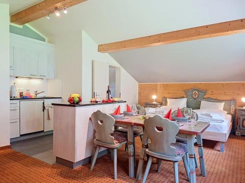 a kitchen and a dining room with a table and chairs at Apartment Chalet Schwendihus-11 by Interhome in Grindelwald