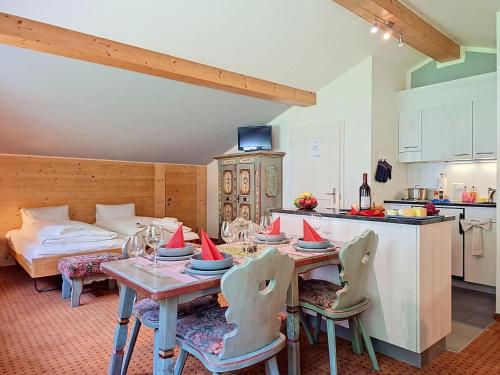 a kitchen and dining room with a table and chairs at Apartment Chalet Schwendihus-11 by Interhome in Grindelwald