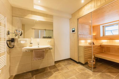a bathroom with a sink and a shower at Jaga Alm in Zell am See