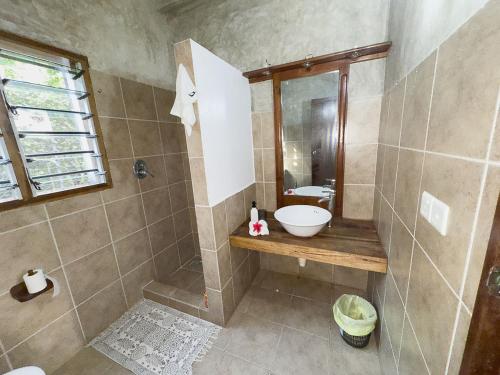 a bathroom with a shower with a sink and a toilet at Beverly Suites - Two Bedroom Apartment 2-5min to Beach in Malindi