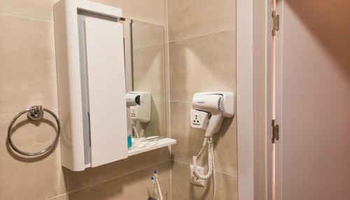 a bathroom with a mirror and a hair dryer at Bazaleti Hut in Bazalet'i