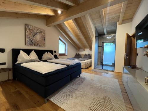 a large bedroom with a bed and a couch at Chalet Maris in Fieberbrunn