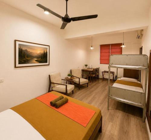 a bedroom with two beds and a dining room at CityRest Fort in Colombo