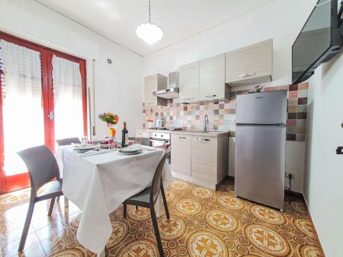 a kitchen with a table with chairs and a refrigerator at Holiday Home SinAgo by Interhome in Lascari