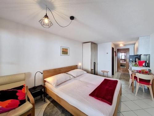 a bedroom with a bed and a dining room at Apartment Haus Bellevue-7 by Interhome in Zermatt