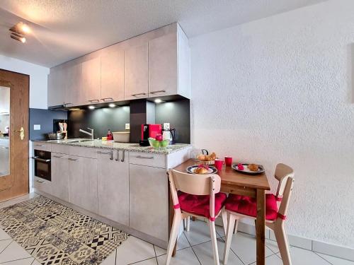 a kitchen with a wooden table with chairs and a tableasteryasteryasteryasteryastery at Apartment Haus Bellevue-7 by Interhome in Zermatt