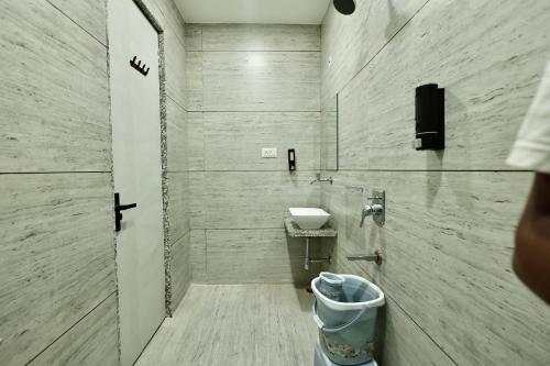 a bathroom with a sink and a toilet at Hotel Maniratna Premium in Indore