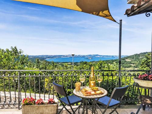 a table with a bottle of wine on a balcony at Holiday Home Casa Martina by Interhome in Montefiascone