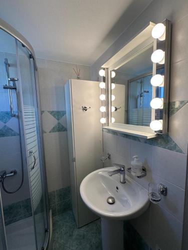 a bathroom with a sink and a shower and a mirror at Villa in Skiathos in Skiathos