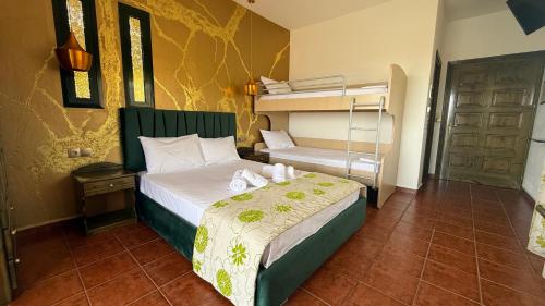 a bedroom with a bed and a bunk bed at Kastro in Skala Potamias