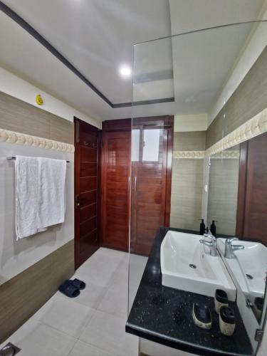 a bathroom with a sink and a glass shower at Stillers Residency in Rahimyar Khan