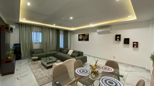 a living room with a couch and a table at Appartement Meublé HS Bonanjo in Douala