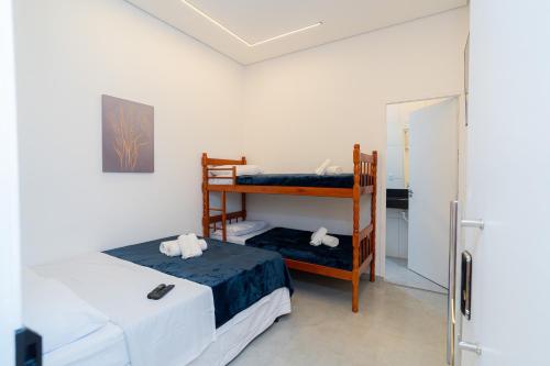 a bedroom with two bunk beds and a refrigerator at AIRPORT HOTEL GRU LTDa in Guarulhos