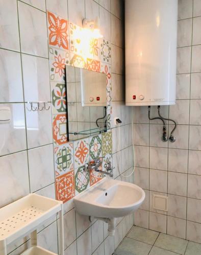 a bathroom with a sink and a mirror at Ryn Lake Resort 2 in Ryn