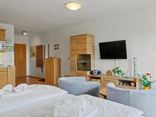 a living room with two beds and a flat screen tv at Apartment Düneneck App-17 by Interhome in Zempin