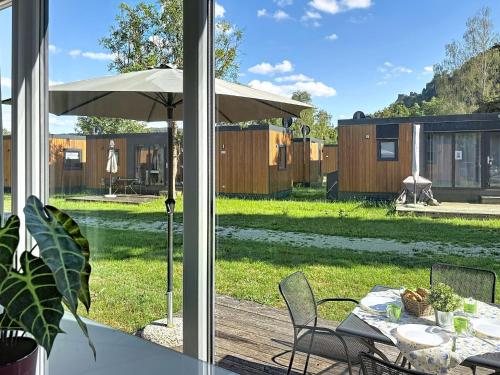 a patio with a table and an umbrella at Holiday Home Tiny Haus Libelle by Interhome in Riedenburg
