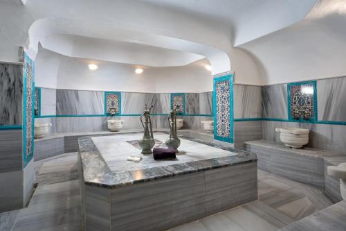 a bathroom with blue and white walls and a sink at Club Titan Hotel Ultra All Inclusive in Kargicak