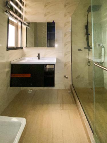 a bathroom with a sink and a shower at Super Star Midak Mews 2 in Lekki