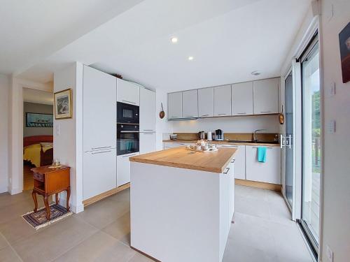 a kitchen with white cabinets and a counter top at Apartment Ty PJP by Interhome in Névez
