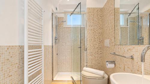 a bathroom with a shower and a toilet and a sink at SkyMare - Beachfront Sea View Apartment in Porto San Giorgio