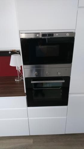 a microwave oven sitting inside of a white cabinet at Chalet Taube in Bad Gastein