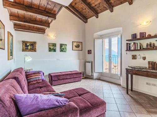 a living room with a purple couch and a table at Apartment Laghina by Interhome in Musso