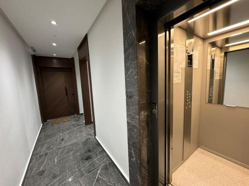 a hallway with a glass door and a hallway with a door at Charming apt with terrace in Kenitra