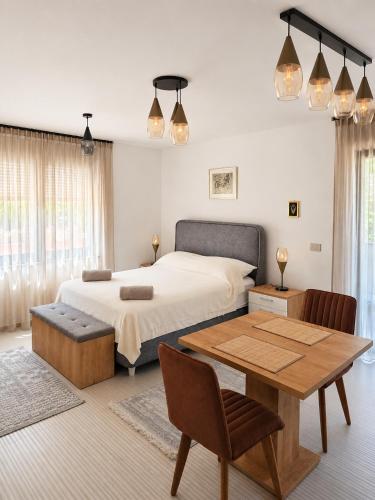 a bedroom with a bed and a table and a table sidx sidx sidx at Apartments Villa Rosa in Rovinj