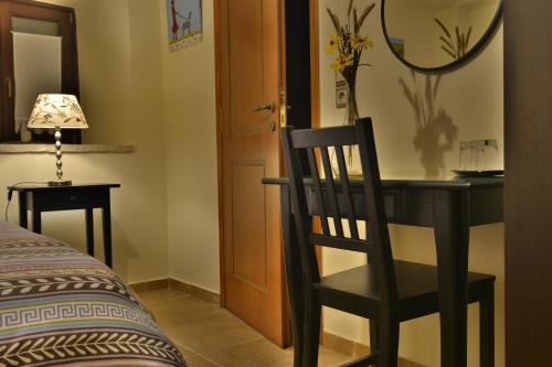 a black desk with a chair and a mirror at Gartagani Guest House in Stemnitsa