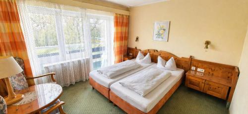 a bedroom with a bed and a large window at Haus BEER in Bad Tölz