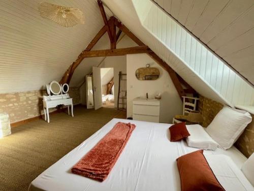 a bedroom with a large white bed in a attic at Le Château de Leugny in Oiron