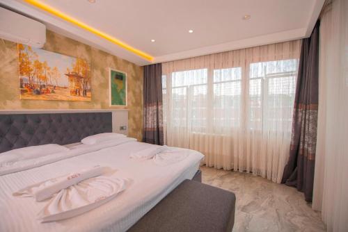 a bedroom with a bed and a large window at Mar Boutique Apartment in Istanbul