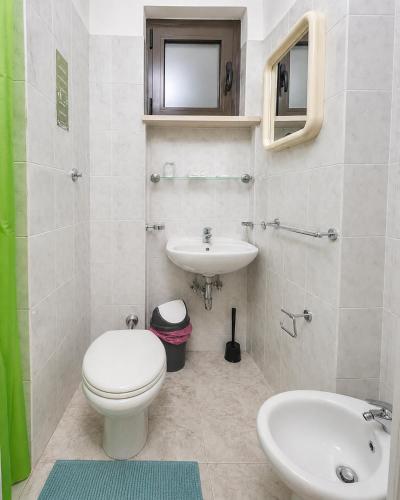 a bathroom with a toilet and a sink at Hotel Ristorante Selene in Alba Adriatica