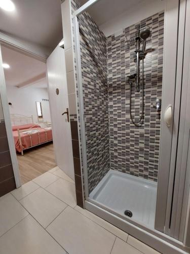 a bathroom with a shower with a glass door at Arena Vacanze in Castellabate