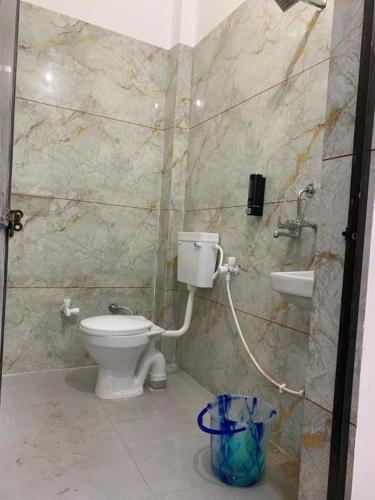 a bathroom with a toilet and a sink at Baloon Rooms Taramandal in Gorakhpur
